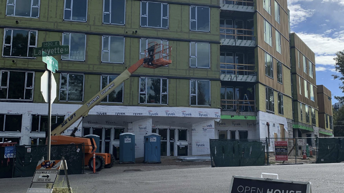 Photo of The Arbory Denver construction with open house sign in front